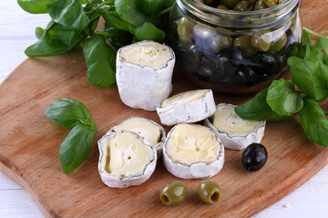 Still life сheese saint-mor-de-Touren on wooden background