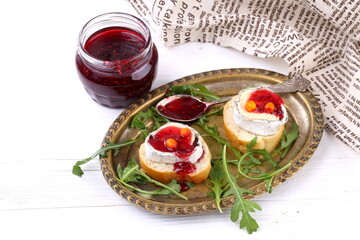 Cheese Saint-Mor-de-Touren with a glass of red wine on a white wooden background
