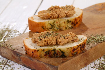 Norwegian cheese brunost on white wooden table