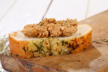 Norwegian cheese brunost on white wooden table