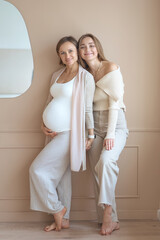 Lesbian couple waiting for baby, woman posing with her pregnant girlfriend. High quality photo