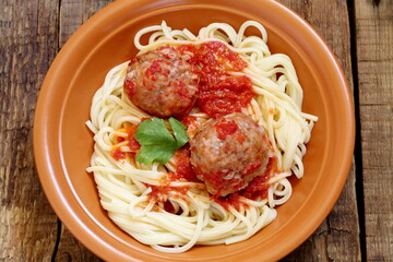 Meatballs in a ceramic plate with beer on a wooden table