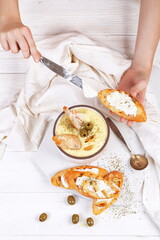 French puree soup with parsnip, soft cheese baguette. Holds a soft cheese sandwich
