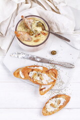 French puree soup with parsnip, soft cheese baguette. Holds a soft cheese sandwich