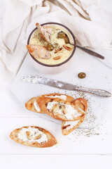 French puree soup with parsnip, soft cheese baguette. Holds a soft cheese sandwich