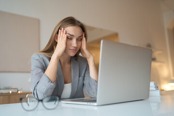 Head shot exhausted young woman taking off glasses, suffer from eyes strain due to computer overwork. Tired unhealthy millennial mixed race lady having painful feelings. High quality photo