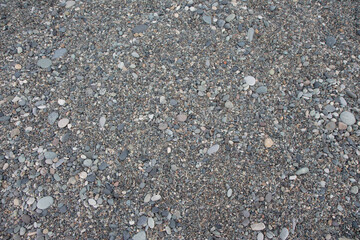 Many type of gravel pebble for Texture Background. Round bright stones at seafront
