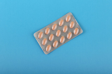 packaging of tablets on  blue medical background top view with copy space