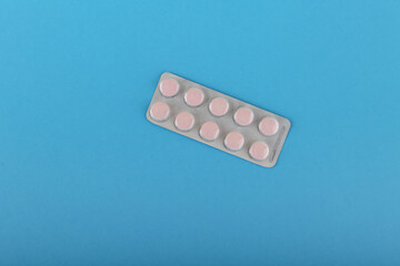 packaging of tablets on  blue medical background top view with copy space