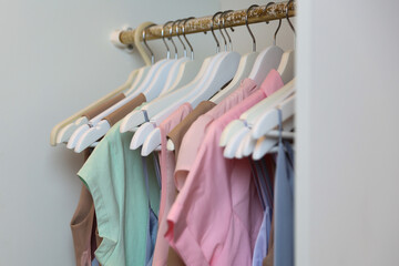 hangers with women's dresses and other colorful clothes