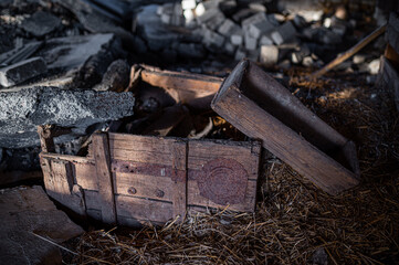 Old abandoned broken wooden crate on dark background