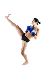 Nude female athlete practicing a kick