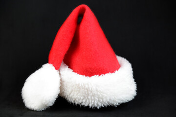 Obraz na płótnie Canvas Santa Claus hat against black background