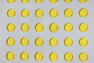 Color of the year yellow and grey background.Grey wall with same round yellow clocks. Time concept background. Trend Color 2021