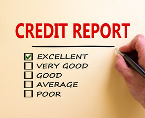 Excellent credit report symbol. Male hand with pen. Words 'credit report' and other business terms on white paper. Business and excellent credit report concept. Copy space.