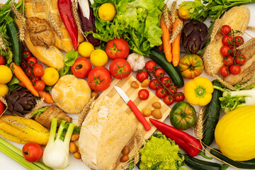 Kitchen table with seasonal vegetable cutting board and fresh bread