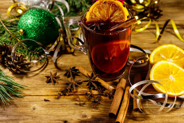 Christmas mulled wine with spices and Christmas decoration on wooden table