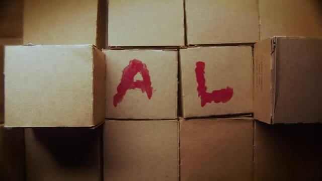 Hand removing cartboard boxes one by one revealing the word SALE with red letters