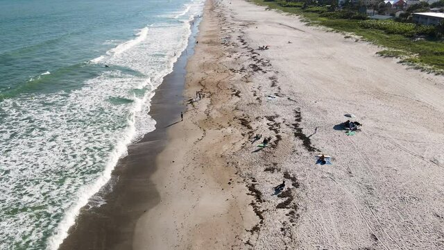 Cocoa Beach Coastline with People on Vacation in Florida, Aerial