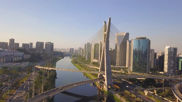 drone flight over the river on estaiada bridge in S&atilde;o Paulo during a sunset on a busy day