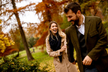 Young couple walking in the autumn park