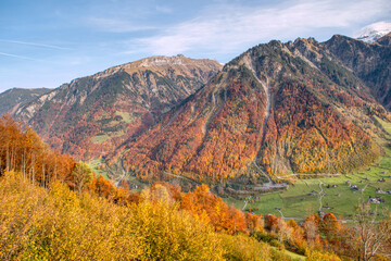 Charming autumn landscape in Swiss Alps. Colorful autumn scene of Swiss Alps. Location: Linthal, Canton Glarus, Switzerland, Europe