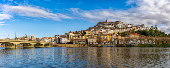 panorama view of the old town of Coimbra in Portugal with river in the foreground