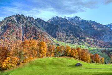 Fototapeta na wymiar Charming autumn landscape in Swiss Alps. Colorful autumn scene of Swiss Alps. Location: Linthal, Canton Glarus, Switzerland, Europe