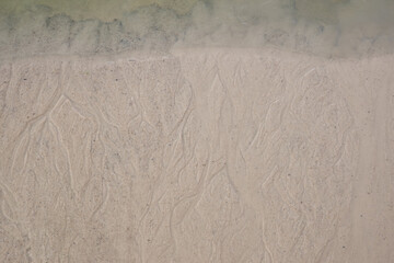 Background blurred by groundwater sandy river bank, first ice on water