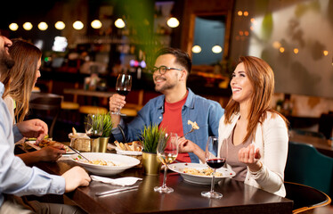 Young people having dinner in the restaurant