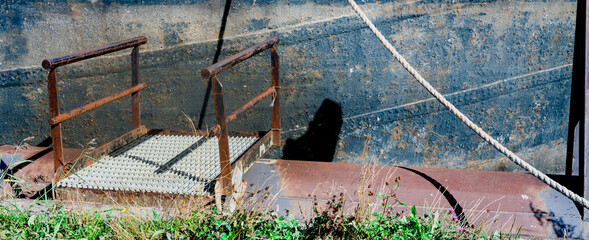 Metal jetty, rusty gangway for ship
