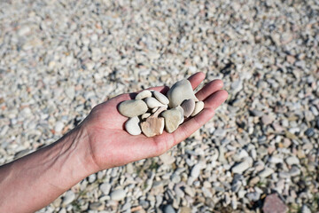 Hand full of stones, pebbles, found on the beach