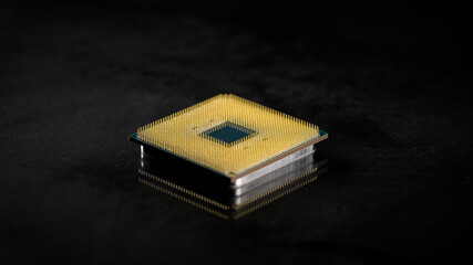 CPU. Studio macro photography of a computer processor. Gold plated contacts are visible in the...