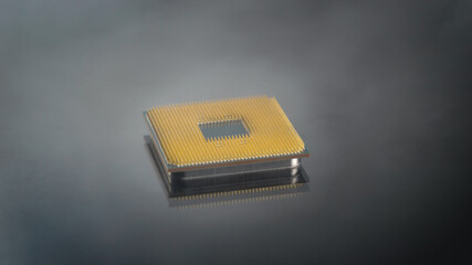 The central processing unit of the computer on a dark background in the smoke. Spectacular shot of an electronic component.