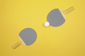 Demonstrating trendy colors of the year 2021. Grey and yellow. Table tennis racket