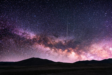 Fototapeta premium Beautiful milky way galaxy on the starry sky over the mountains silhouette. Night photography Astronomical wallpaper.