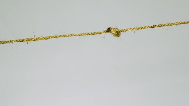 Tightening the knot on the hemp rope