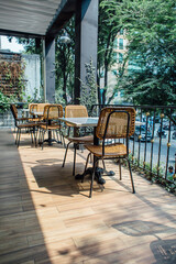 Empty cafe on the second floor with tall palm trees