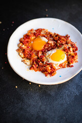 fried eggs with tomato and vegetables shakshuka omelette natural organic snack ready to eat on the table healthy meal snack top view copy space for text food background rustic keto or paleo diet