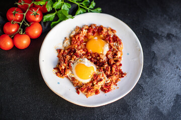 fried eggs with tomato and vegetables shakshuka omelette natural organic snack ready to eat on the table healthy meal snack top view copy space for text food background rustic keto or paleo diet
