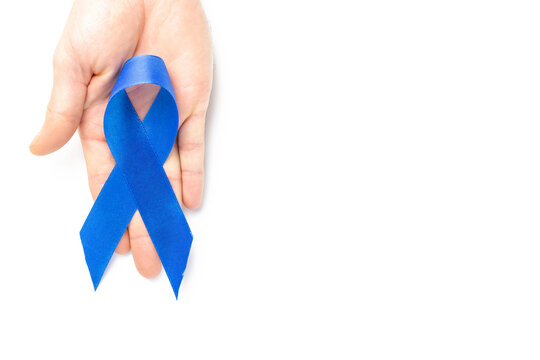 Cancer awareness blue. Blue ribbon in hands isolated on white background. Awareness prostate cancer of men health in November. Movember and International Mens Day.