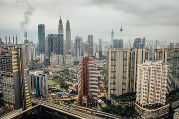 Plakat cityscape with skyscrapers, Petronas towers can be seen in the picture, there is strong smoke pollution in the background