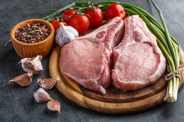 fresh raw new-york steak on wooden Board on wooden background with salt and pepper in a rustic style.