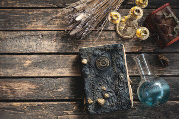 Spell book and magic potion on the old table. The witchcraft.