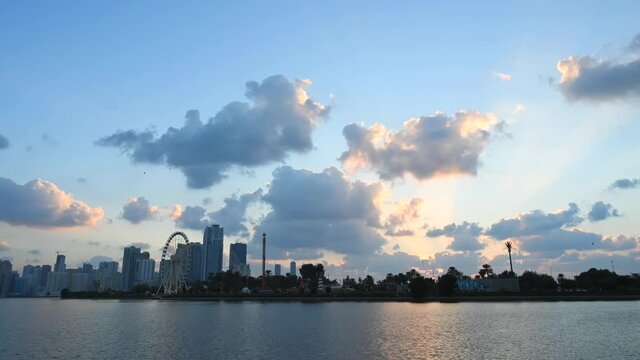 UAE-Dec 2020: Timelapse of the grey clouds floating above the downtown buildings of Khalid Lagoon, Sharjah, United Arab Emirate. 4k Footage