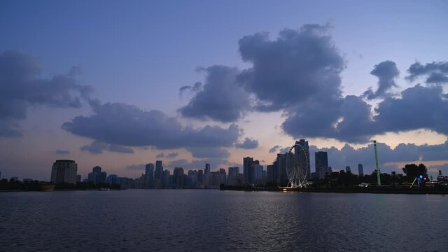 UAE-Dec 2020: Timelapse of the grey clouds floating above the downtown buildings of Khalid Lagoon, Sharjah, United Arab Emirate. 4k Footage