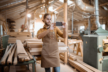 Carpenter using phone in the workshop