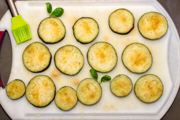 Eggplants cut into slices and prepared for baking