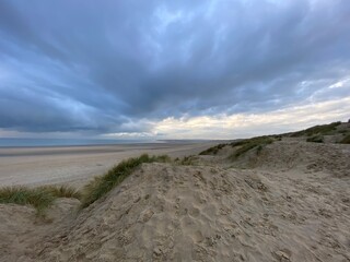 Camber sands beach, Rye, East Sussex UK, Camber is a flat sandy beach with giant sand dunes on South coast England and popular with tourists and daytrippers in Summer 