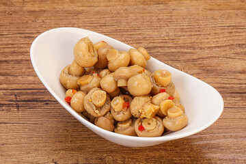 Pickled champignons in the bowl